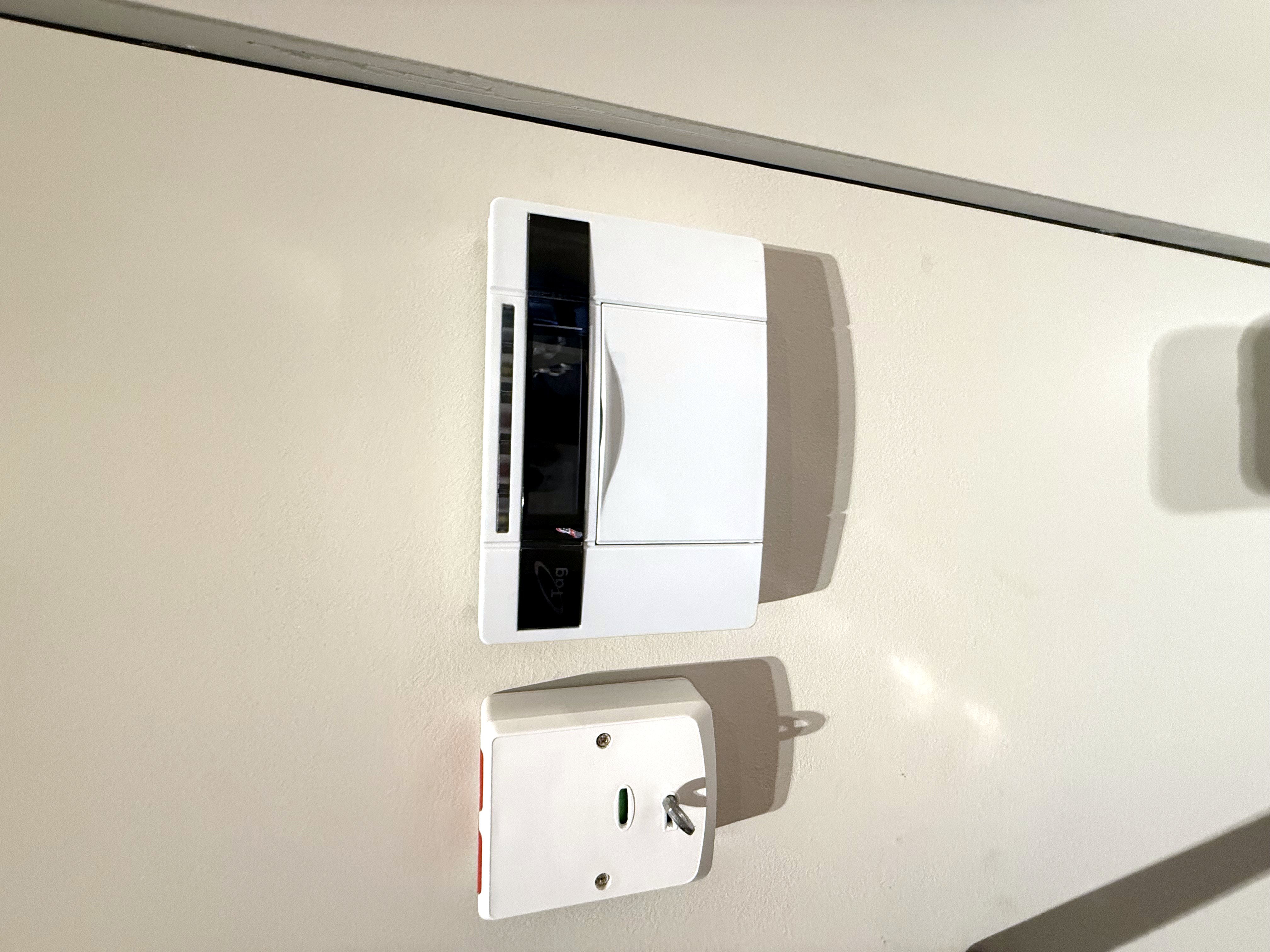 Intruder alarm control panel and keyswitch mounted at the entry point of a property