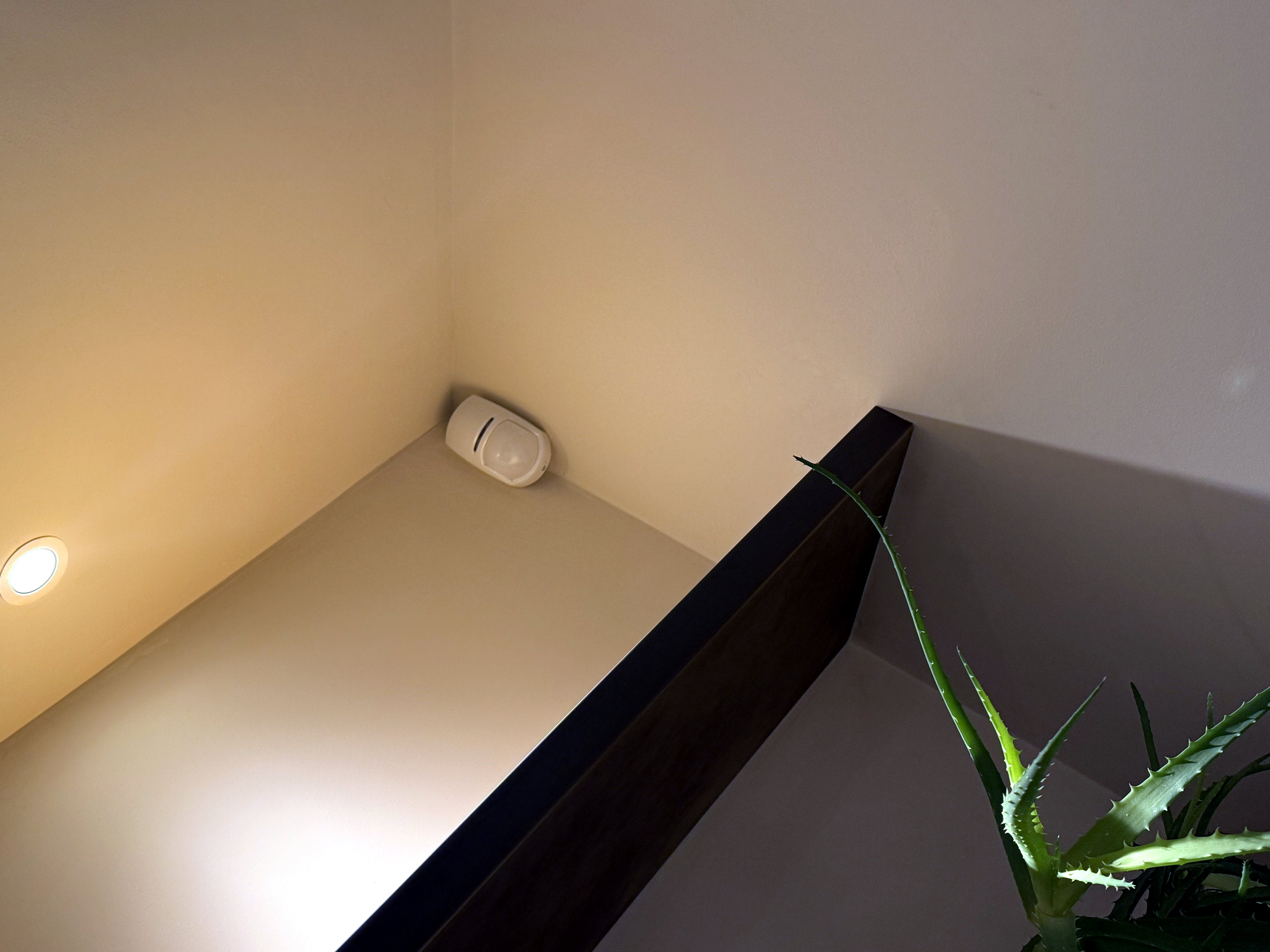 Motion detector fitted at high level above a stairwell landing